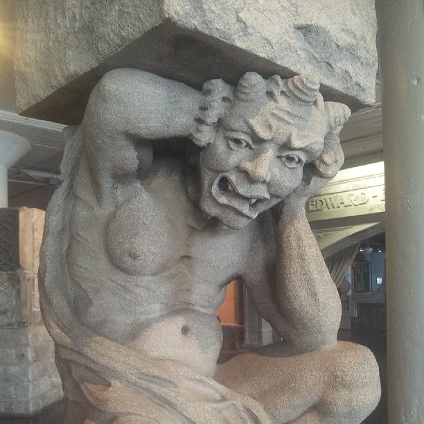 Statue of a groaning man under a burden, from the St. Louis City Museum