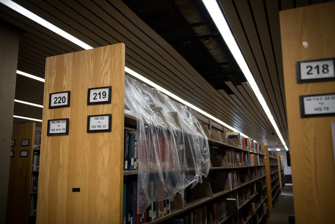 "Library shelves at Lehman College, part of the CUNY system, have been covered with plastic since a leak three years ago." <-NYTimes caption