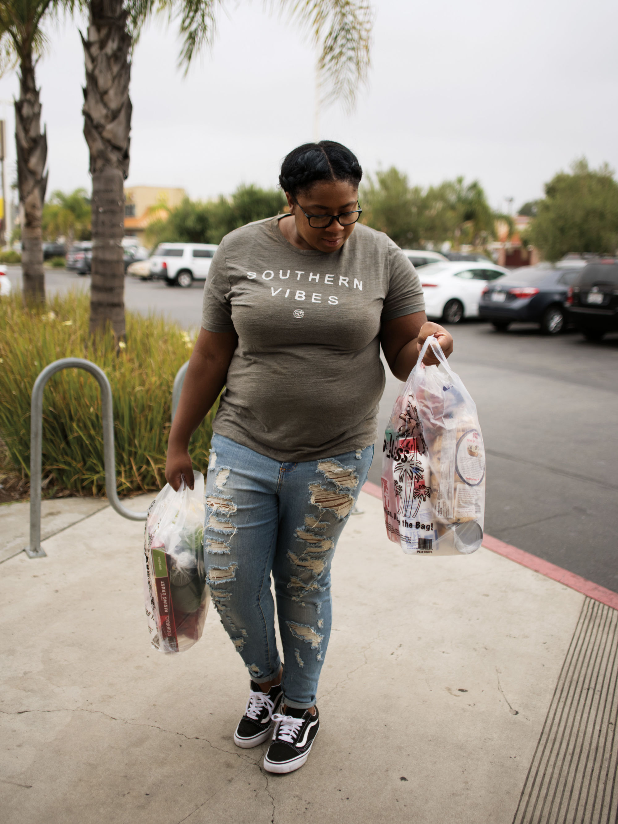 "Kersheral leaving Food 4 Less with her groceries"