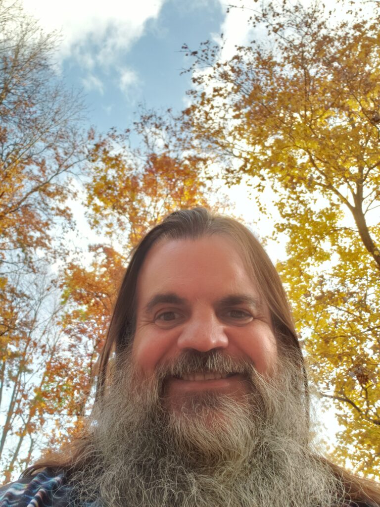 Bryan out of isolation against yellow leaves blue sky